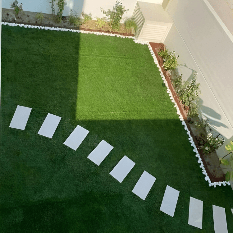 A beautiful and vibrant garden with a variety of flowers and plants, creating a serene and inviting atmosphere. https://ideallandscapers.com/